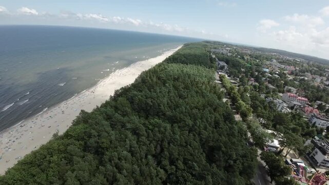 This aerial footage showcases the stunning Jastrzebia Gora beach in Poland, capturing its natural beauty and the vibrant atmosphere during the summer season. The video begins with a breathtaking