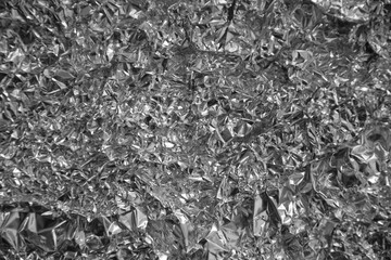 Processed collage of shiny metal silver gray foil crumpled packaging material texture