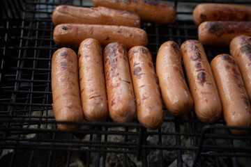 Charcoal sausages. Food in the air. Meat sausages on fire.