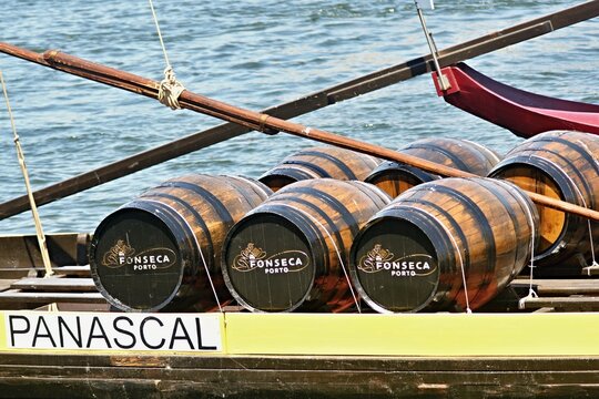 Traditional Fonseca Port wine barrels on a transport boat in Porto - Portugal 