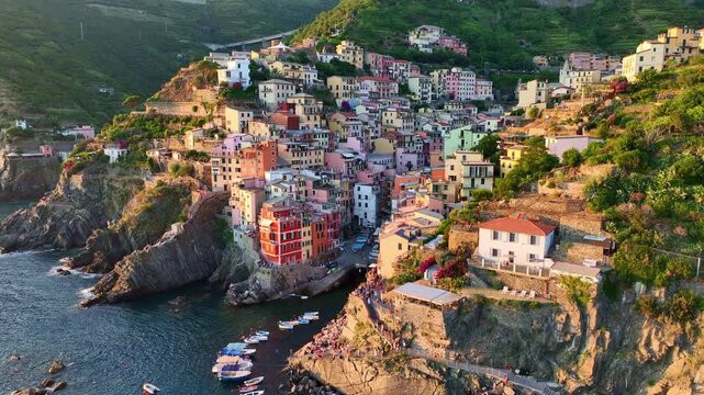 Drone view of Cinque terra coast in Italy, Italian riviera in Liguria aerial view, fishing village of Riomaggiore at sunset, holiday in Cinque Terre, Italy 