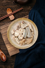 Food pig large intestine, wooden tabletop and dark background