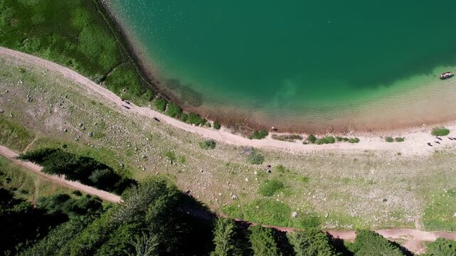 Aerial view of an emerald lake and the shore. Canoe boat on a lake. Black lake Zabljak Durmitor Montenegro national parc