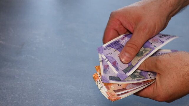 India money. Converter of larger cash of 100, 200 and 500 Indian rupees. Copy space. Beautiful dark background