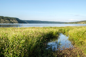 Landscape of Bakota River and mountains Ukraine Dniester River. Photo of the flooded village.   .   .