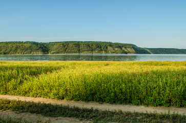Landscape of Bakota River and mountains Ukraine Dniester River. Photo of the flooded village.   .   .