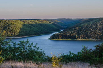 Landscape of Bakota River and mountains Ukraine Dniester River. Photo of the flooded village.   .   .