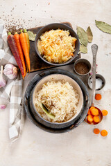 Winter salad on wooden light background. Homemade sauerkraut cabbage withcarrot. Tasty