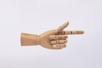 Wooden hand pointing or clicking with index finger isolated on white background. Copy Space. Concept of presenting and offering