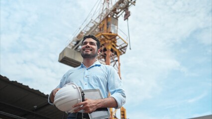 Portrait of engineer with tower crane for lift and move objects on building construction sites