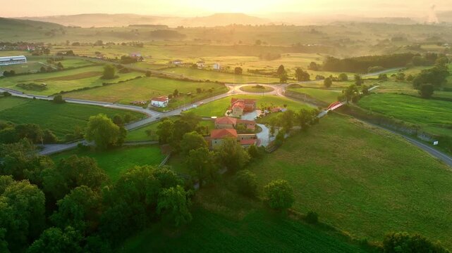 beautiful summer aerial view of rolling green fields at sunrise, green meadow on a foggy morning in Galicia, Spain, Camino de Santiago in Spain