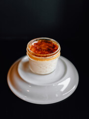 delicious dessert with creamy sweet cheese and fresh fragrant strawberries in a beautiful glass cup in a cozy nice restaurant