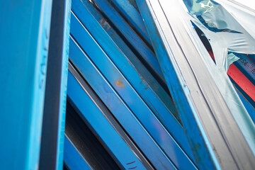 Silk screen printing screens stored in a outdoors in a metal rack ready for printing. Replacing and...
