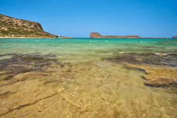 Scenic landscape of the Mediterranean sea on Crete, Greece. Mountains in the background and blue, clear sky.