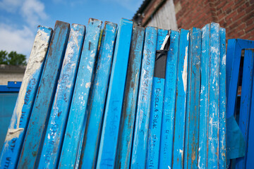 Silk screen printing screens stored in a outdoors in a metal rack ready for printing. Replacing and...