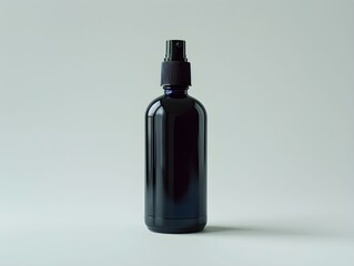 Dark glass spray bottle on a plain background