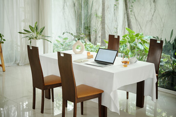 Dining table with laptop in the dining room
