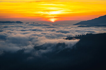 Fototapeta premium beautiful sunrise behind mountain range with sea of clouds in the northern of Thailand (Tak province)