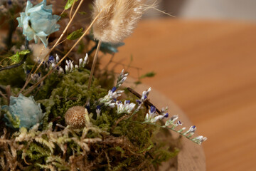  Female hand decorating a miniature floral arrangement