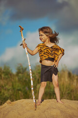 Cute baby dressed in the clothes of primitive people