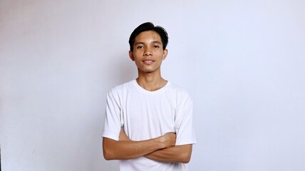 Obraz premium Handsome Asian young man smiling posing crossing both arms on chest