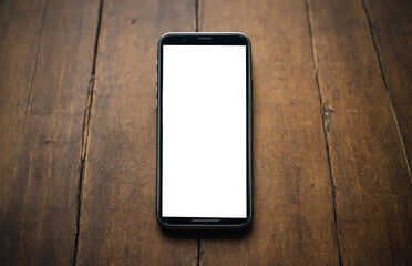 phone with blank screen copy space on wooden table