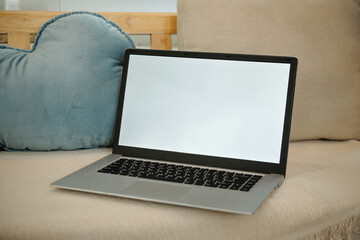 Fototapeta premium Close-up of laptop on sofa in the living room
