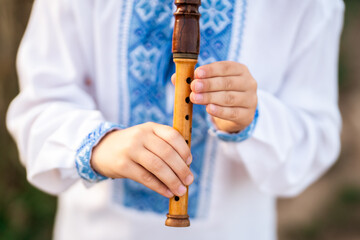Hands Of Little Boy Kid Playing On Woodwind Wooden Flute - Ukrainian Sopilka