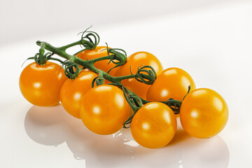 Yellow sweet tomato on the branch