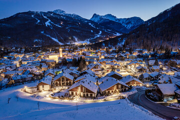 Panoramic view from above at nightfall of the snowy village of Bardonecchia, a ski resort in the Alps in Piedmont, Italy.
