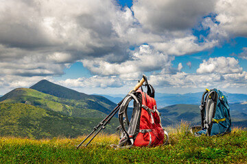 Hiking in the mountains with two backpacks in the summer.