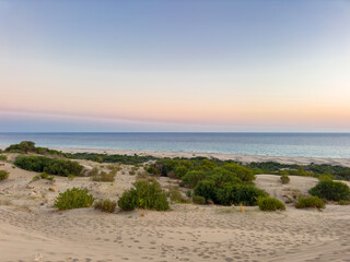 Beautiful orange sunrise sky background over sea with yellow sunlight reflection on sea surface in golden hour time, panoramic view. patara sand dunes
