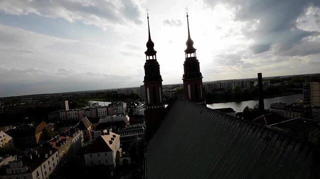 A flight over Opole, Poland, starting from the tower of the Cathedral of the Holy Cross. We can see the main points of interest of the city, such as the Market Square, the Town Hall, and the Holy