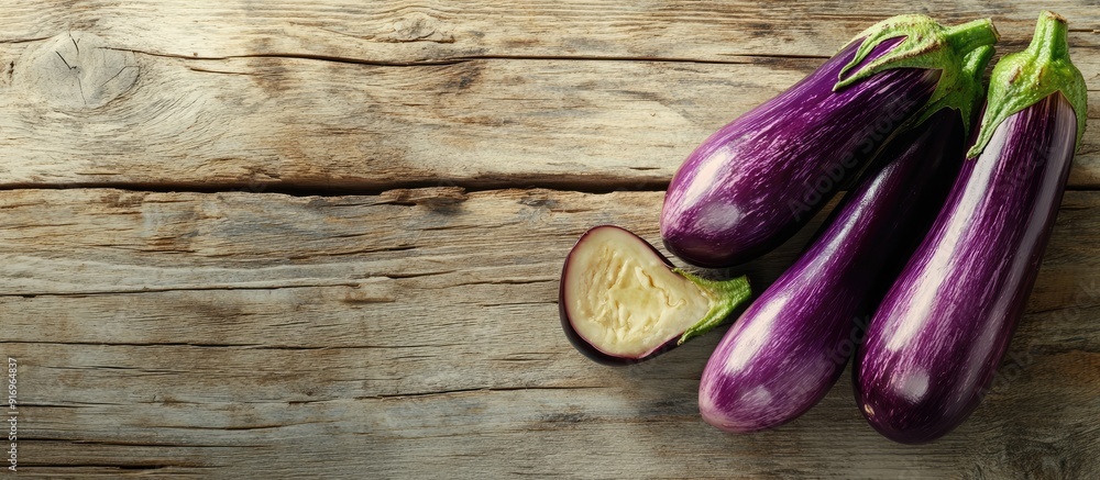 Aufkleber half cut eggplants on a distressed chic light wood table. with copy space image. place for adding te