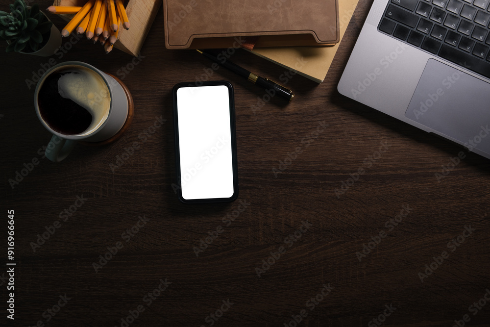 Wall mural modern workplace with smart phone notebook on wooden table. copy space and blank screen for your adv