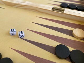 Backgammon game. Wooden board with backgammon game pieces with dice
