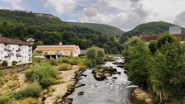 Mountain landscape in France with a river and a waterfall. Morning idyll in the mountains.