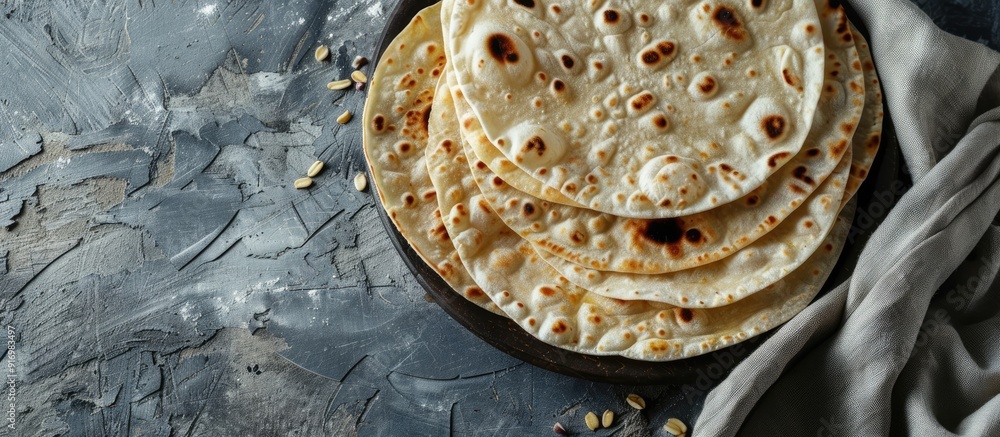 Poster indian chapati bread on gray backdrop highlighting vegetarian food with copy space image