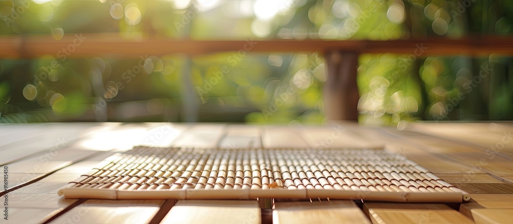 Poster wooden deck table with a bamboo place mat ideal for displaying items with copy space image
