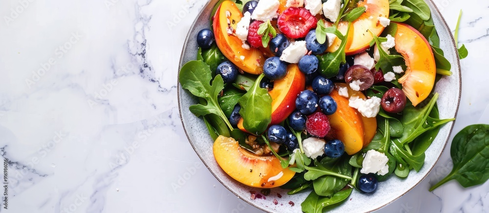 Poster healthy vegetarian salad featuring nectarines blueberries arugula spinach and feta cheese on a white