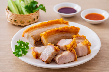 Crispy pork belly on white plate and dipping sauce