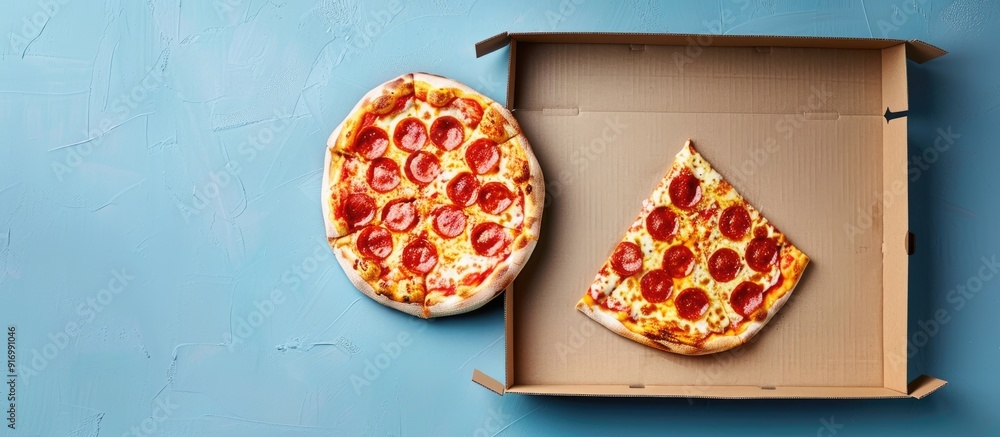 Aufkleber pizza box on a light blue backdrop with empty copy space image