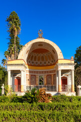 Path with vibrant green trees in city park, Villa Giulia. Palermo, Sicily, Italy