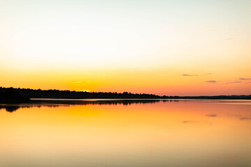 Sunset on the river. Reflection on the water.