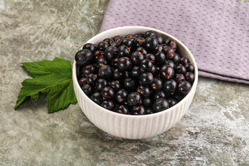 Ripe black currant in the bowl