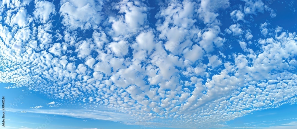 Aufkleber Blue sky with lovely altocumulus and cirrocumulus clouds featuring a mix of small fluffy clouds at different altitudes perfect for copy space image