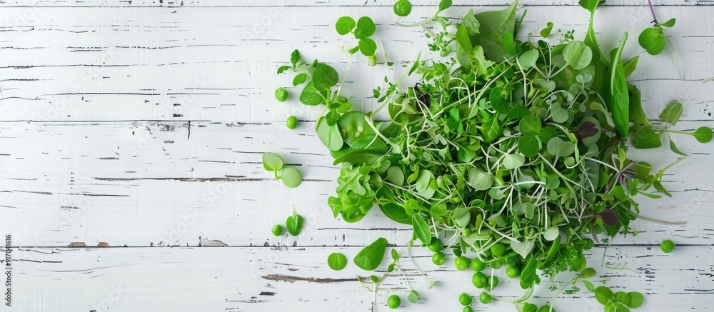 Poster top view of a vegetarian green pea salad with microgreens and vegetables on a white wooden surface p