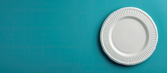 Paper plate attached to blue wall with copy space image