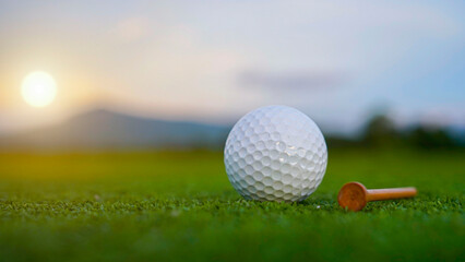 Golf ball is on a green lawn in a beautiful golf course with morning sunshine.
