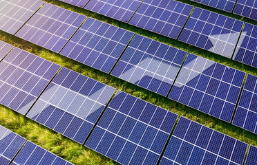 Upward line graph with arrow superimposed on rows of solar panel. Representing growth in...